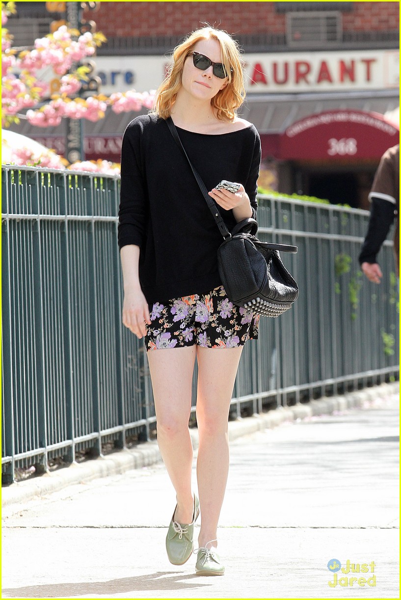 Emma Stone seen playing with her iPhone while walking alone in New York City